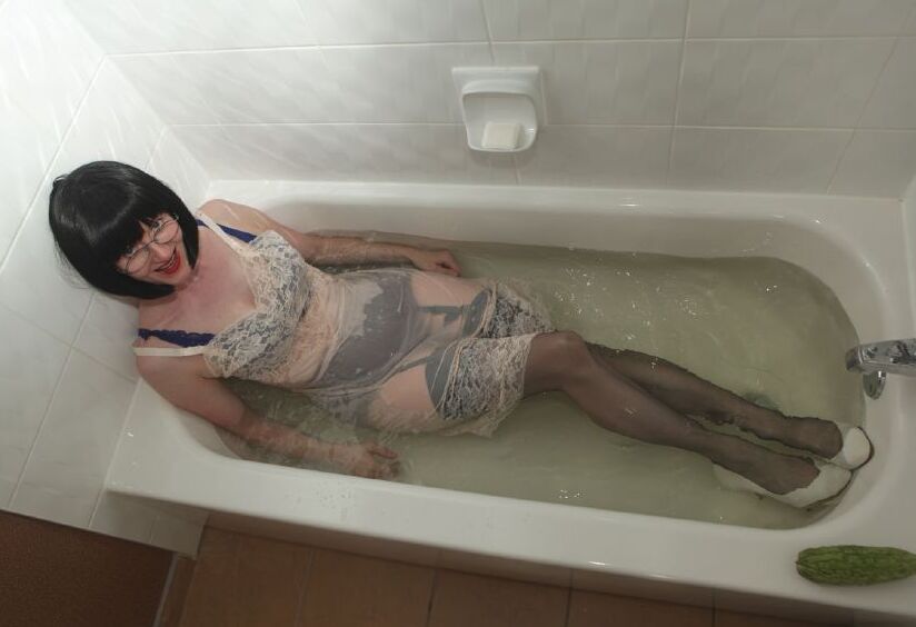 12P Dressed mature lady in black nylon stockings taking a bath