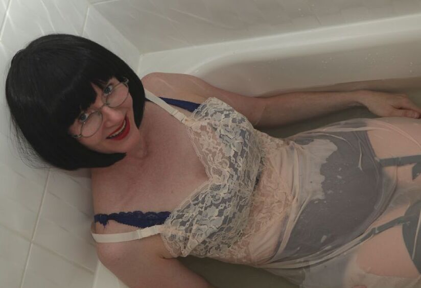 12P Dressed mature lady in black nylon stockings taking a bath