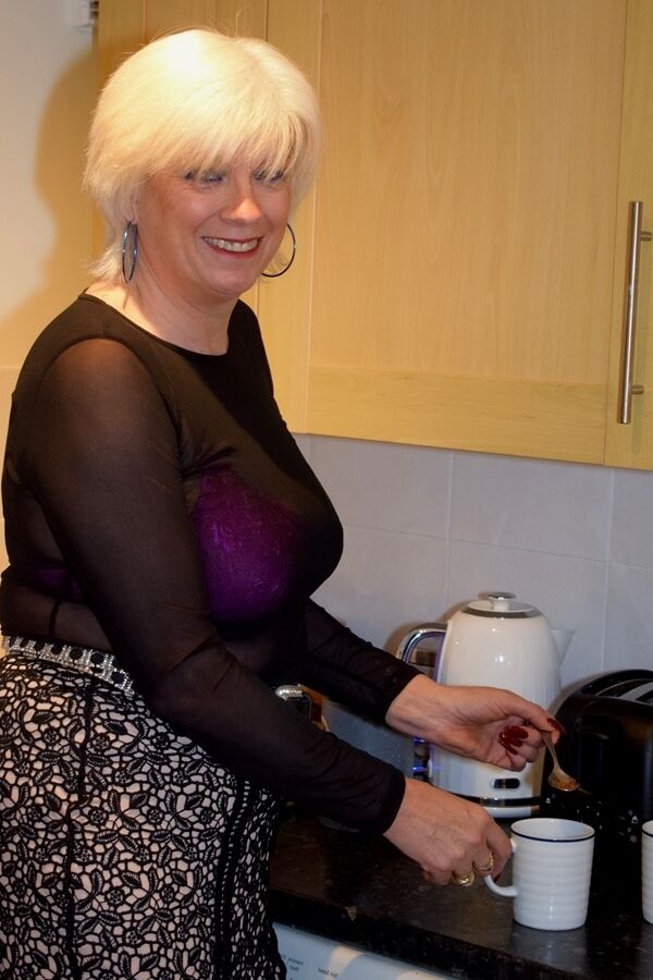 16P Mature platinum blonde prepares a stir fry while fully clothed