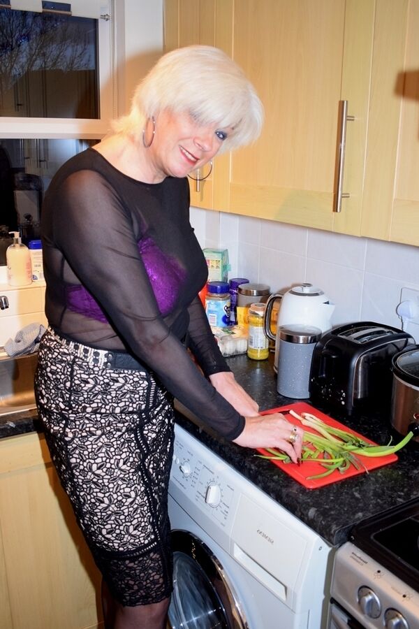 16P Mature platinum blonde prepares a stir fry while fully clothed