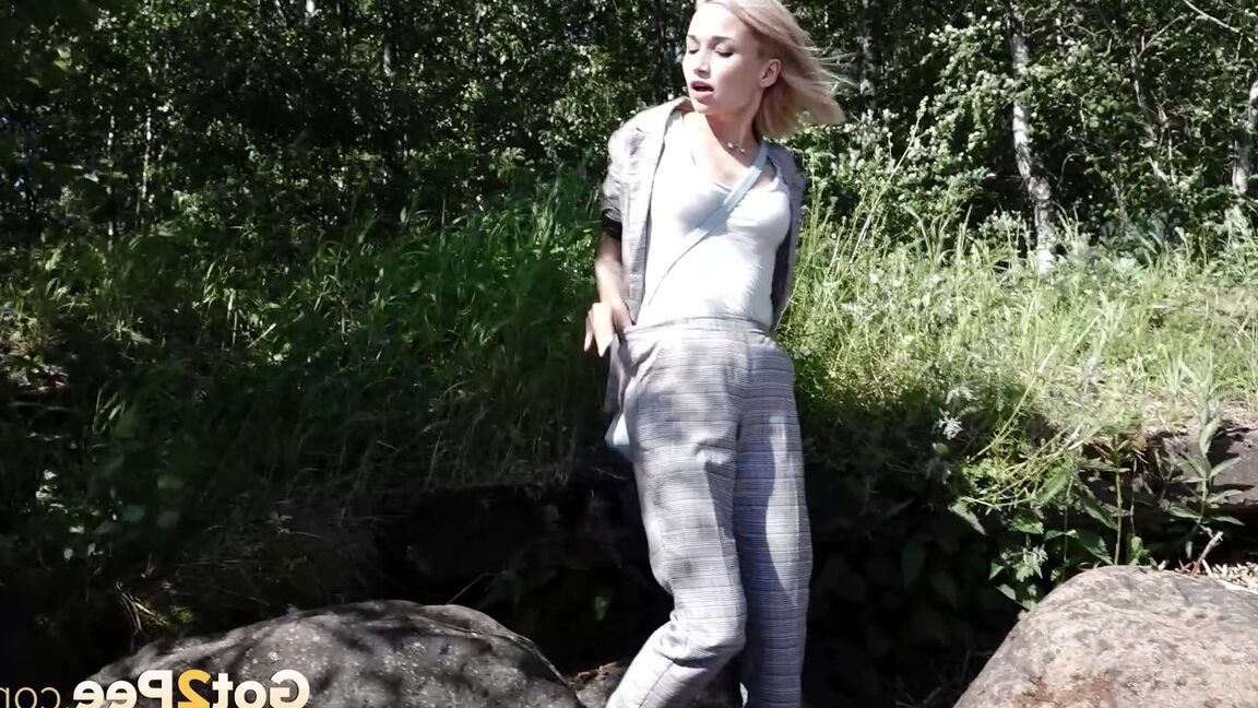 15P Blonde girl Masha squats for a piss between a couple of boulders