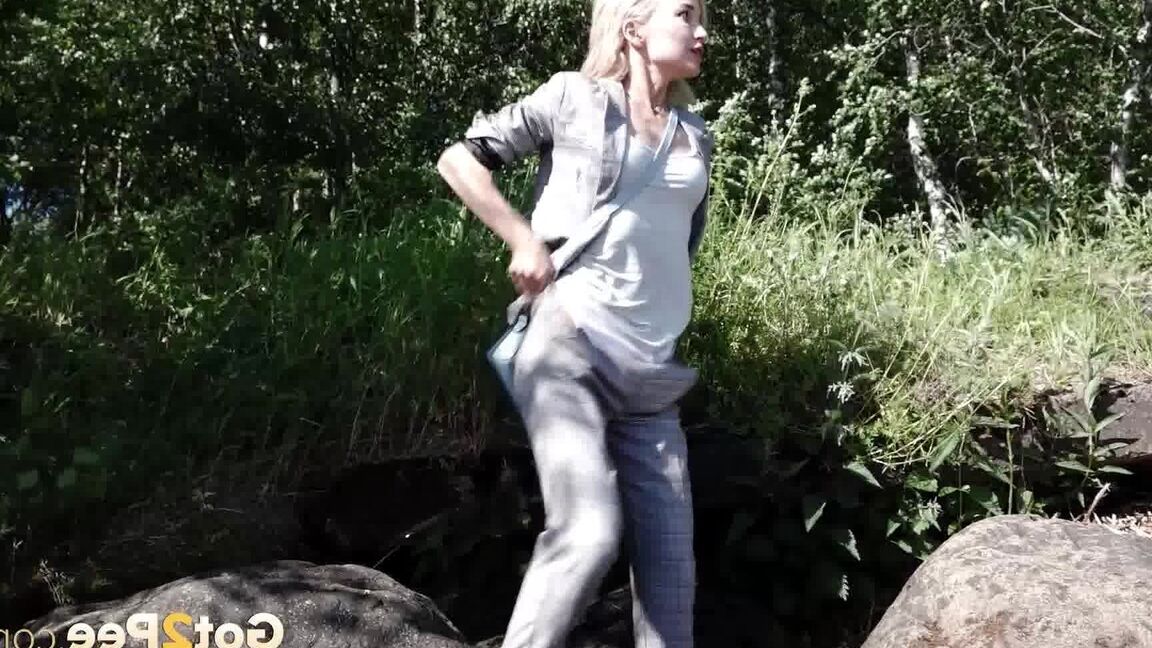 15P Blonde girl Masha squats for a piss between a couple of boulders