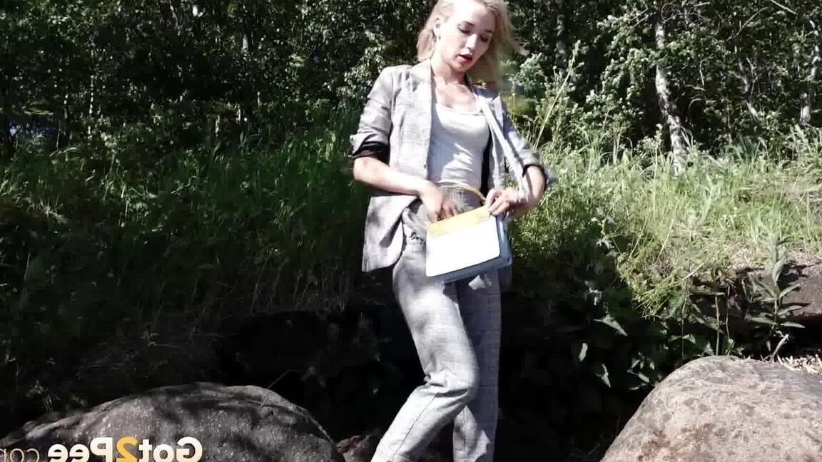 15P Blonde girl Masha squats for a piss between a couple of boulders