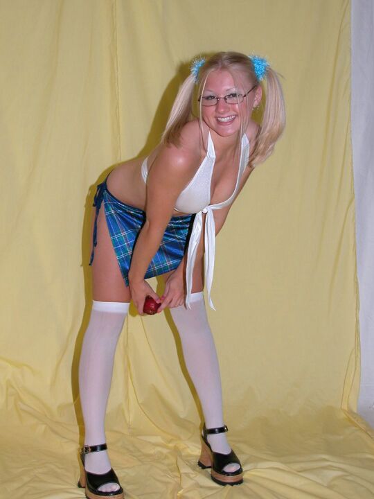 12P Young looking blonde poses for a non-nude shoot in pigtails and OTK nylons