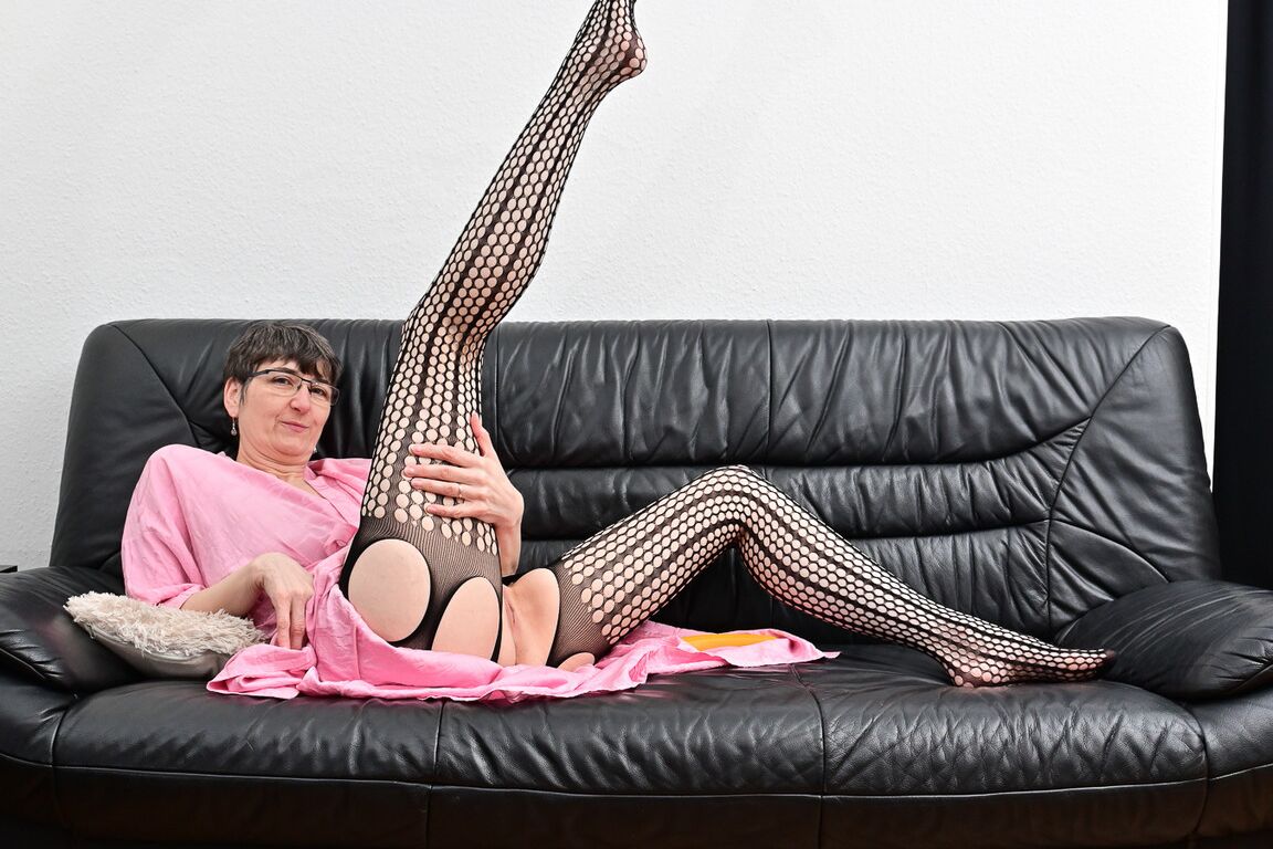 20P Mature woman wears glasses while masturbating with a carrot on a leather couch