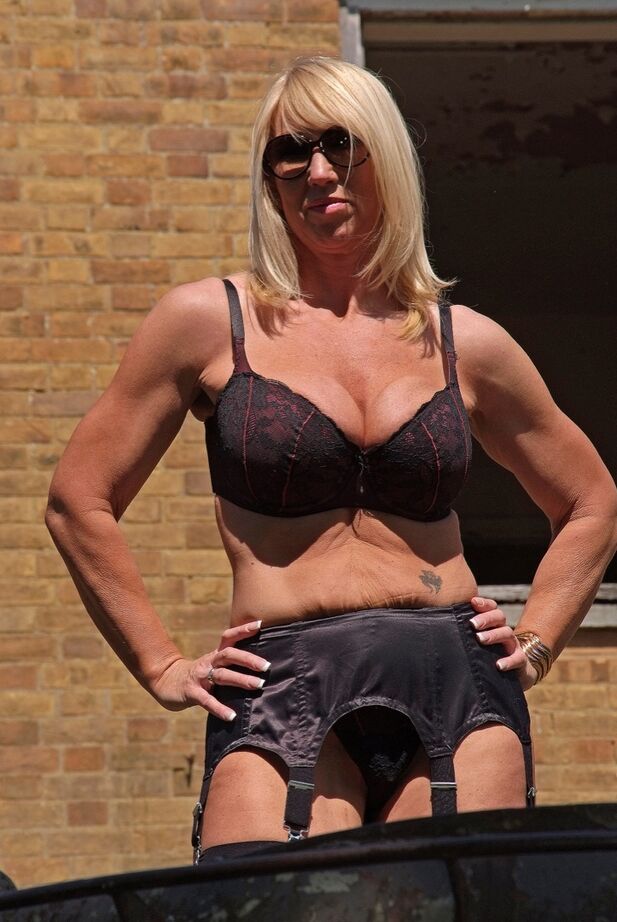 20P Tall blonde Melody goes topless in garters and nylons on a tank