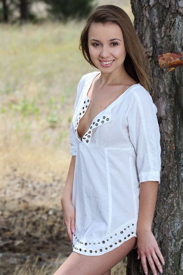 18P Sweet tiny titted brunette Linda Chase undressing to spread naked in a tree