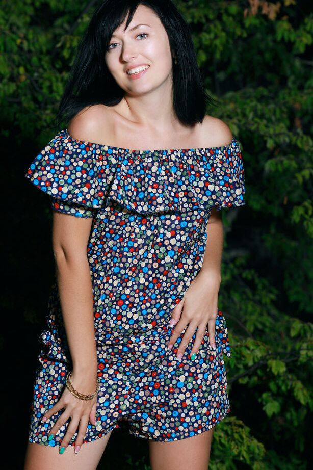 18P Dark haired teen Ramina gets bare naked in a yard next to fir trees