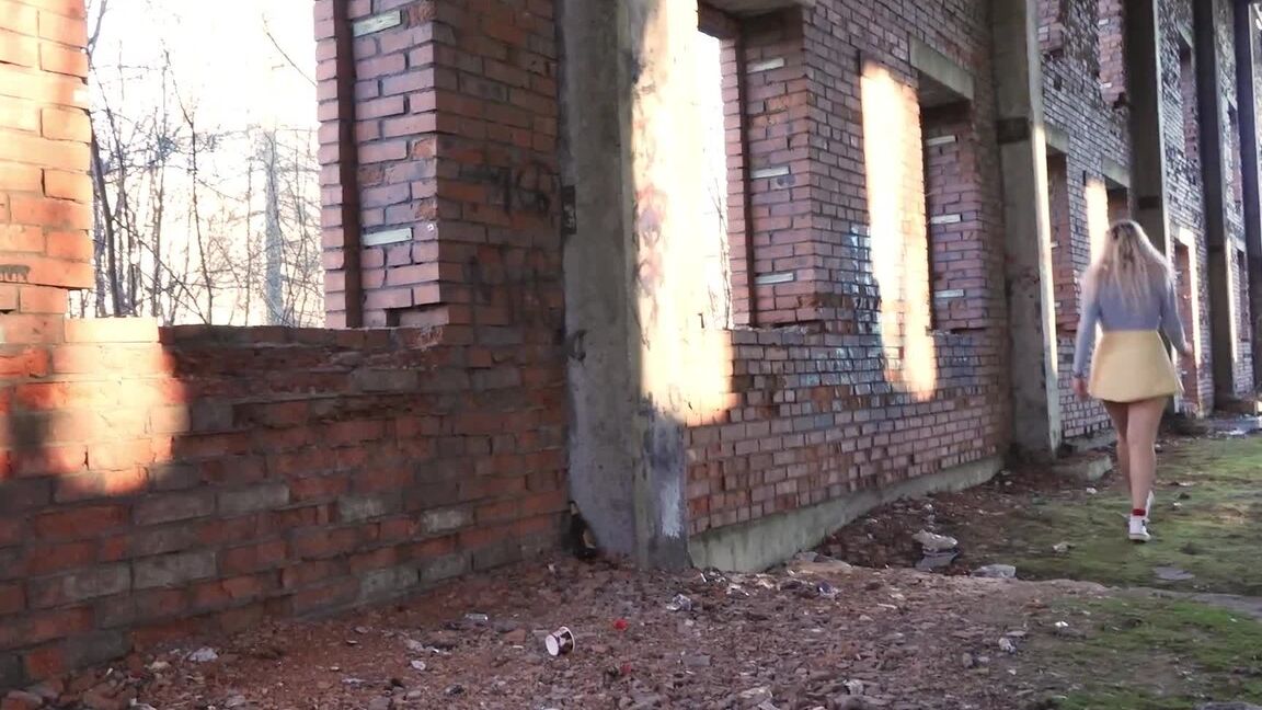 15P Blonde chick squats for a piss by an abandoned brick building