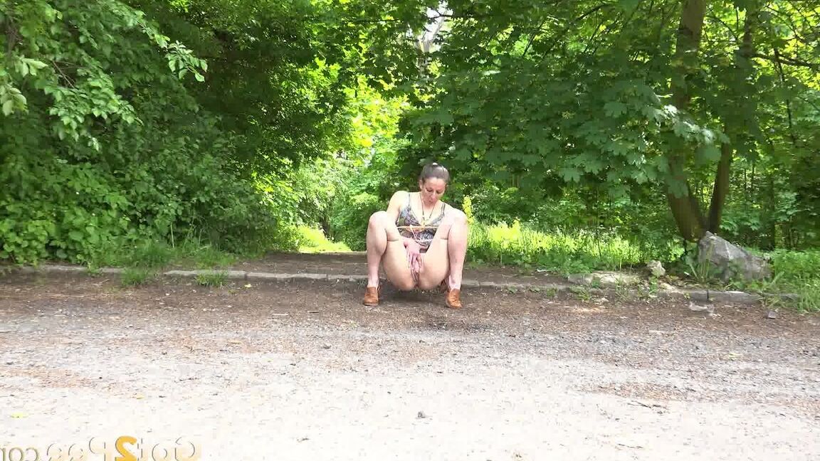 15P Caucasian chick Valentina Ross squats to pee in a parking lot near the woods