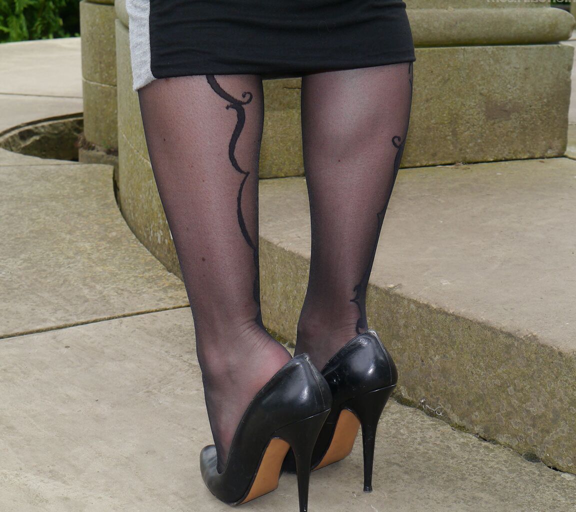 16P Clothed woman Sophia descends park steps in a long skirt and stiletto heels