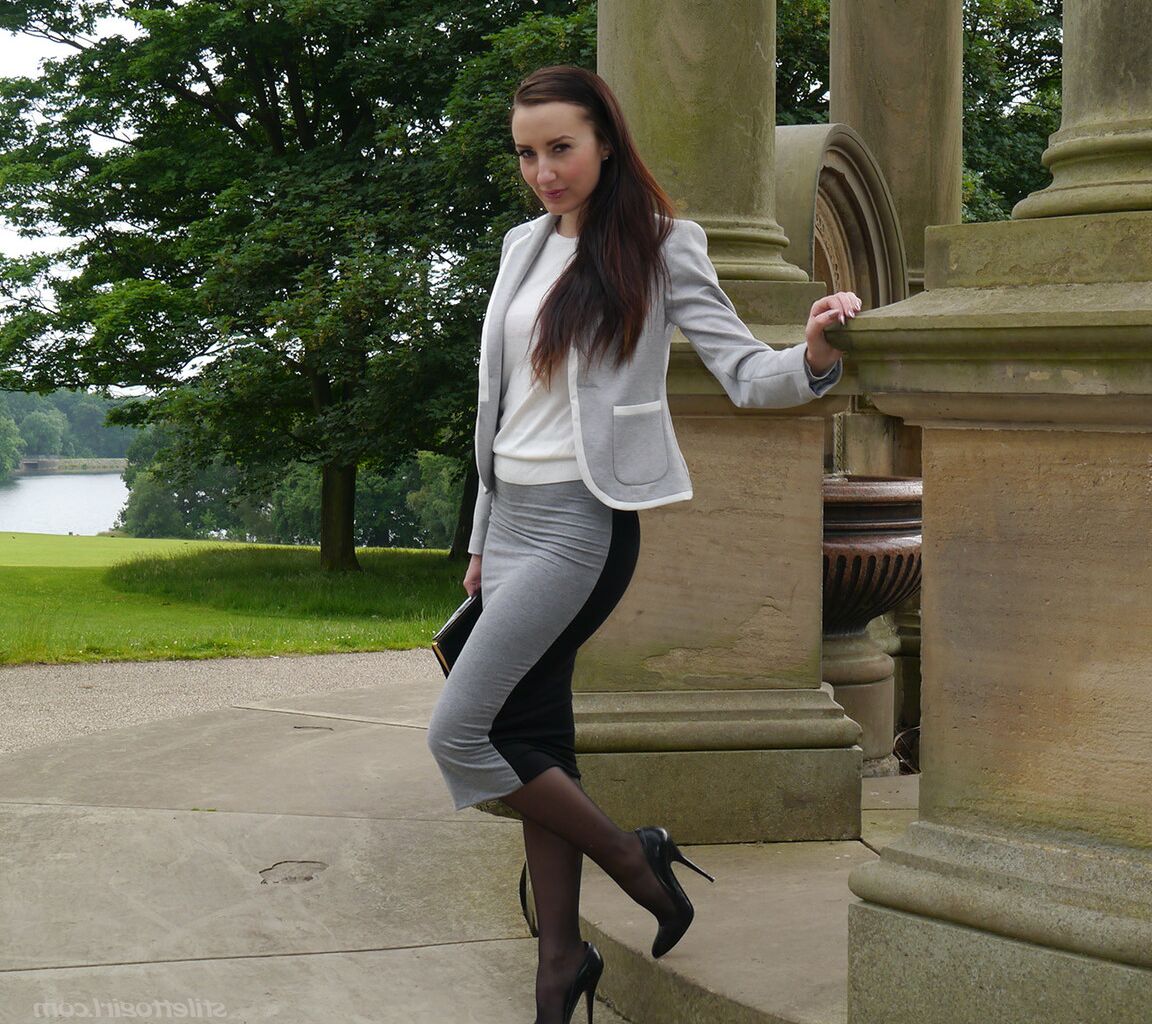 16P Clothed woman Sophia descends park steps in a long skirt and stiletto heels