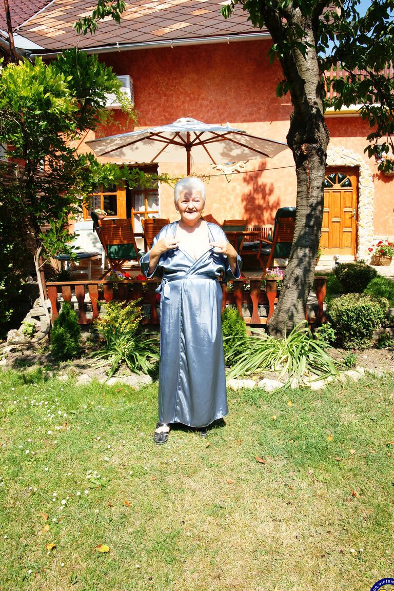 21P Crazy old granny Vera D drops her robe and masturbates in the back yard