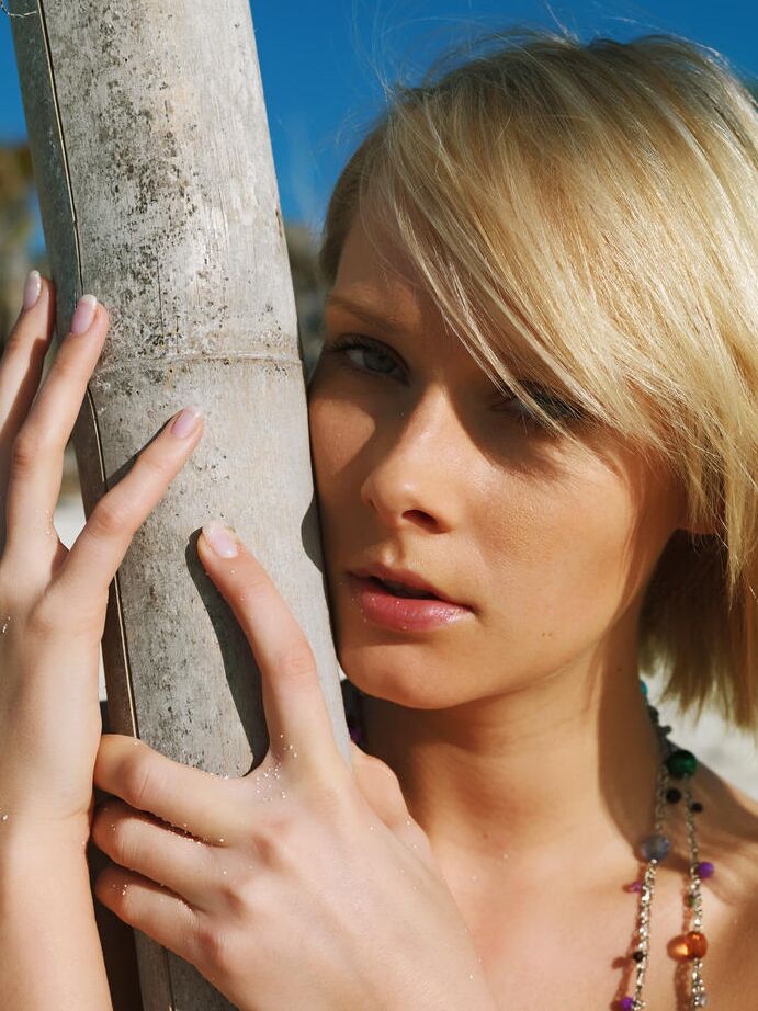 16P Pretty blonde Deni models completely naked on a sandy beach