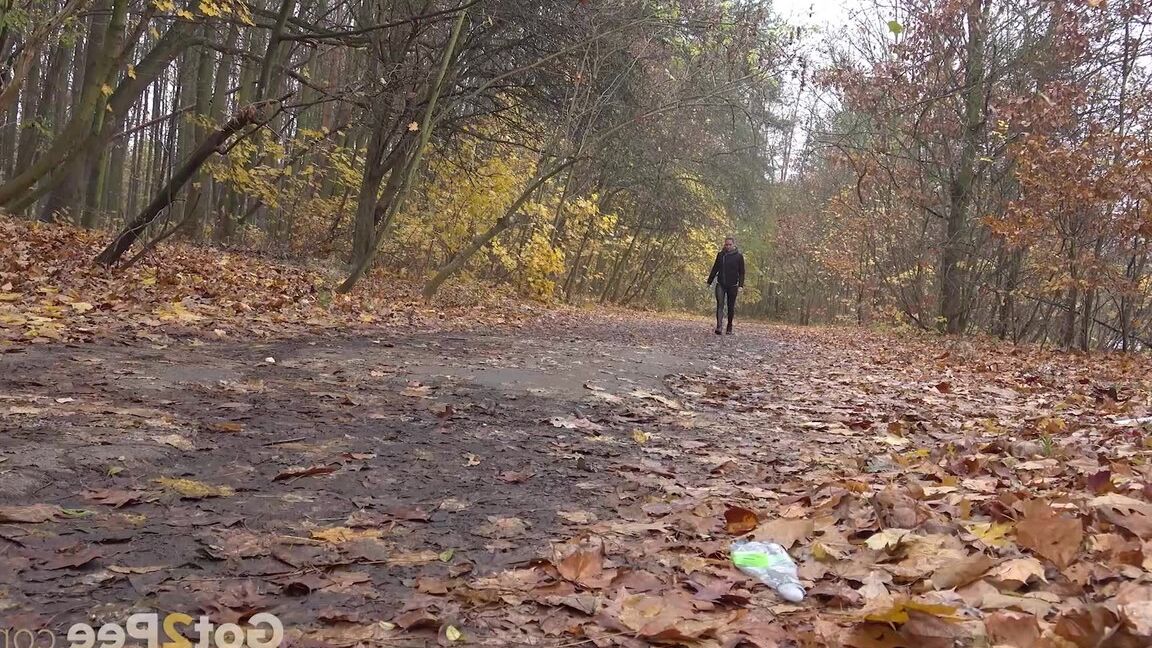 15P White girl Naomi Bennet takes a pee on a path while walking through a forest