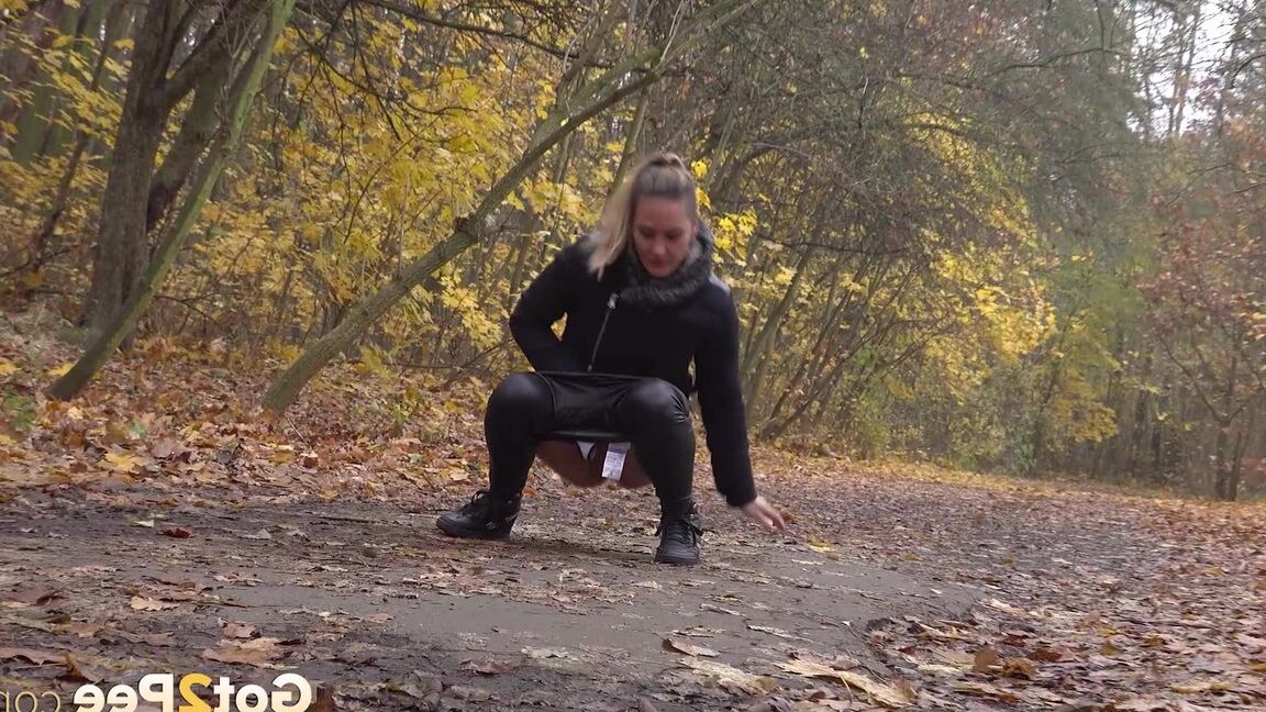 15P White girl Naomi Bennet takes a pee on a path while walking through a forest
