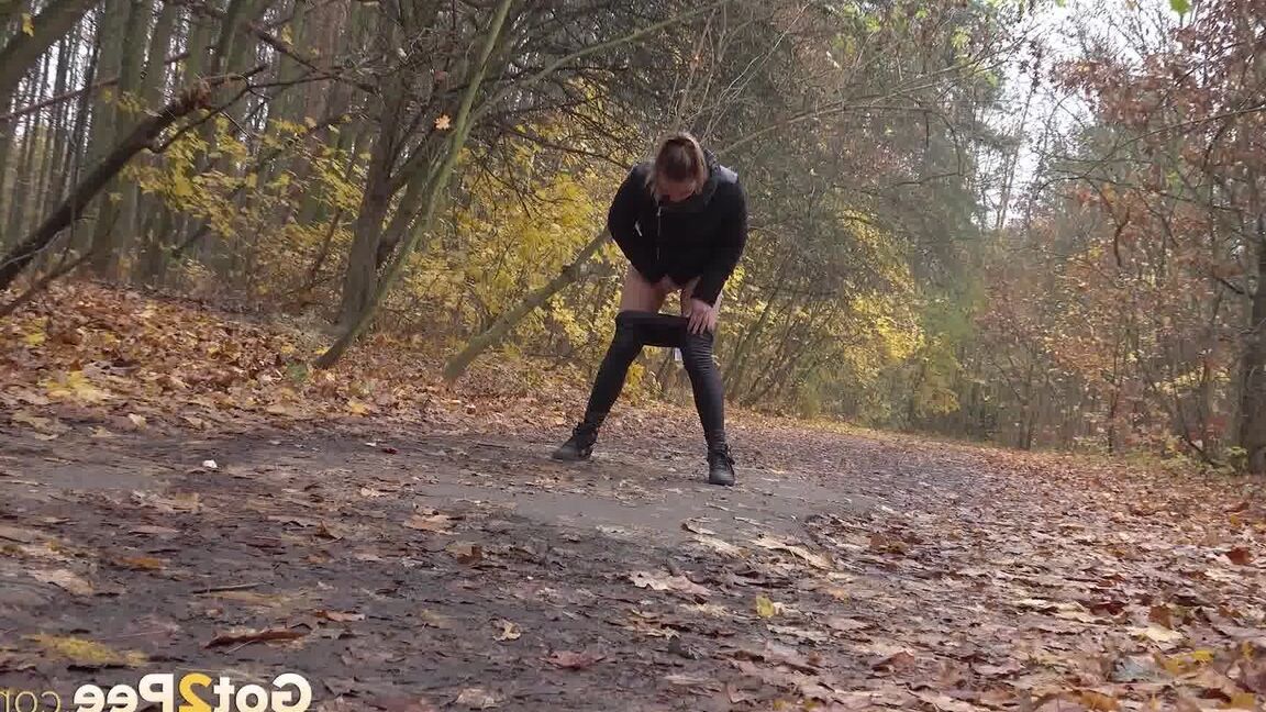 15P White girl Naomi Bennet takes a pee on a path while walking through a forest