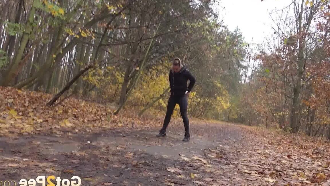15P White girl Naomi Bennet takes a pee on a path while walking through a forest