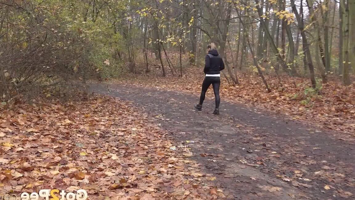 15P White girl Naomi Bennet takes a pee on a path while walking through a forest