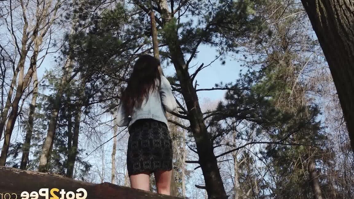 15P Short taken girl Katya holds her ass while taking a piss in the woods