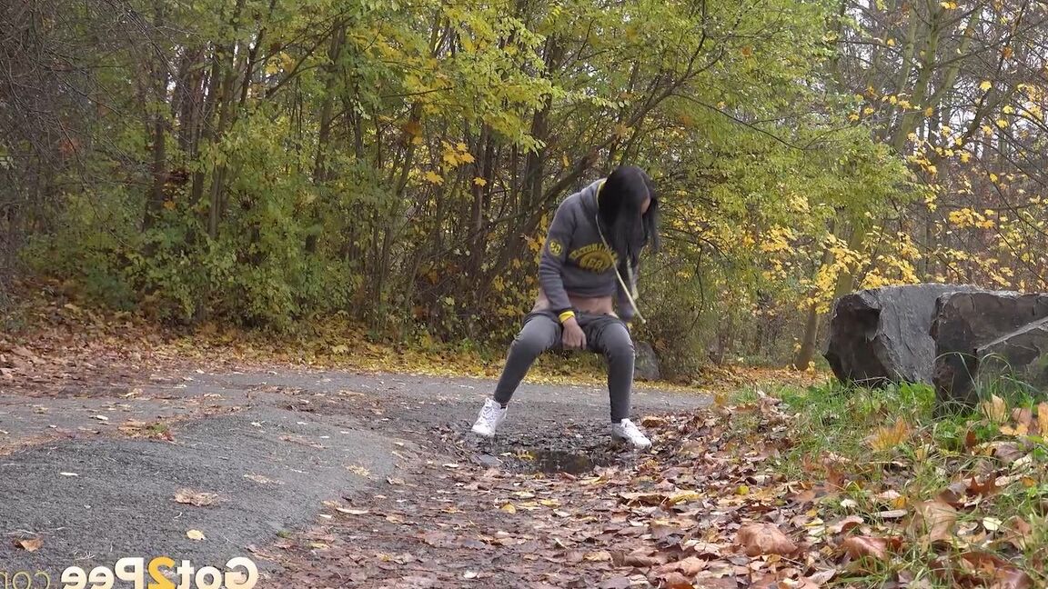 15P Mistica, une fille aux cheveux noirs, fait pipi sur un chemin en marchant dans une zone boisée