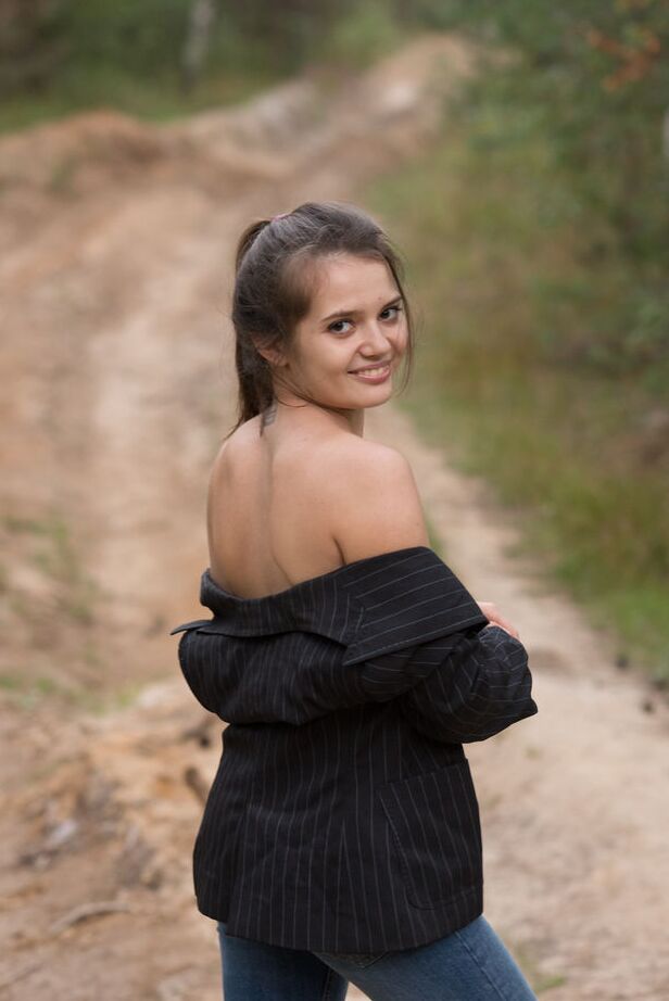 16P Teen model Pola strips naked on a dirt path running thru the woods