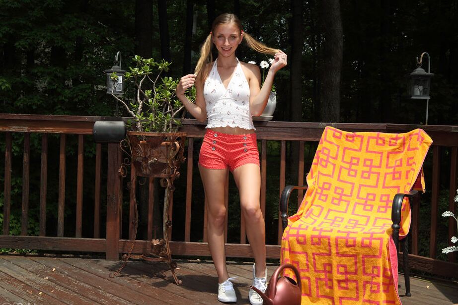 16P Blonde teen Macy Meadows waters her twat after clamping it wide open on a deck