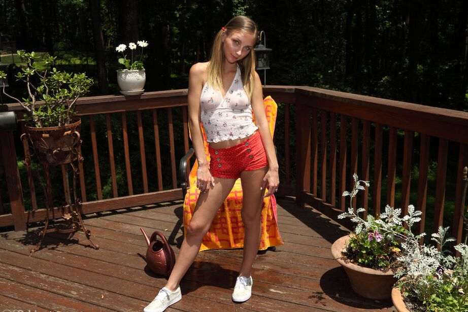 16P Blonde teen Macy Meadows waters her twat after clamping it wide open on a deck