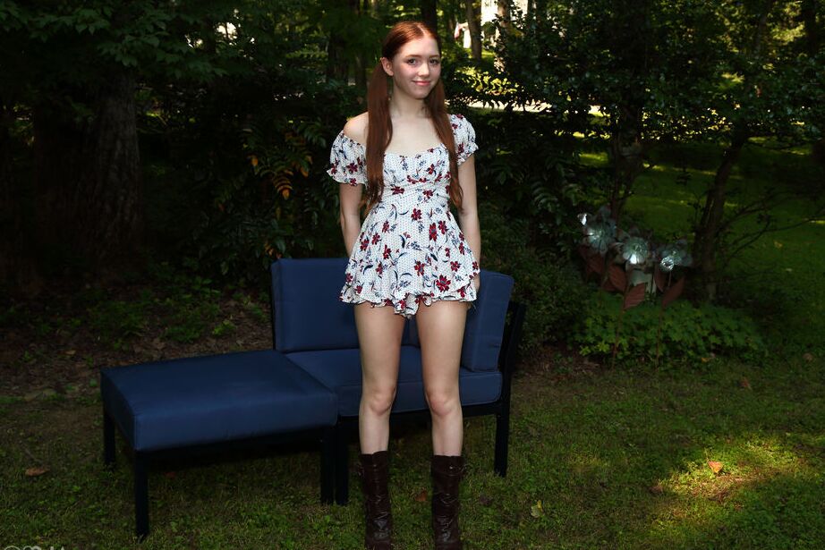 16P Young redhead Myra Glasford clamps her pussy wide open on a sofa in a yard