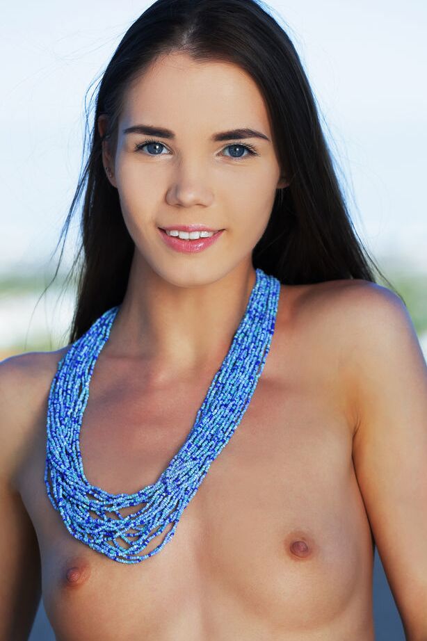 18P La hermosa joven Lovenia Lux muestra con confianza su cuerpo desnudo junto a una piscina