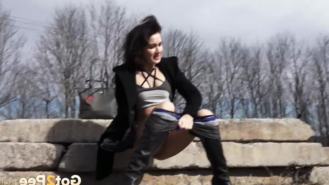 15P Bombasse aux cheveux noirs en leggings serrés fait pipi dehors