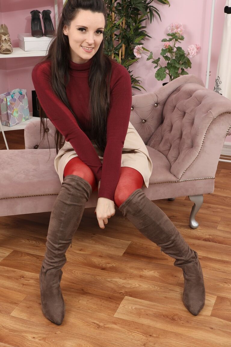 16P Brunette chick Ivy Rain goes topless before slipping red hose over her ass