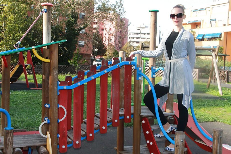 16P Lovely Christelle is showing her fine feet on a children playground