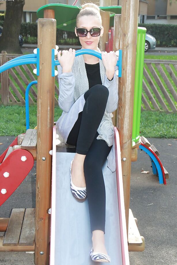 16P Lovely Christelle is showing her fine feet on a children playground