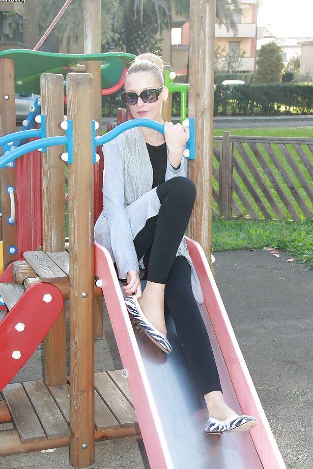 16P Lovely Christelle is showing her fine feet on a children playground
