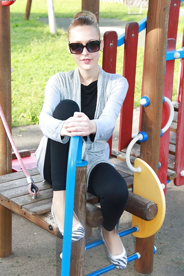 16P Lovely Christelle is showing her fine feet on a children playground