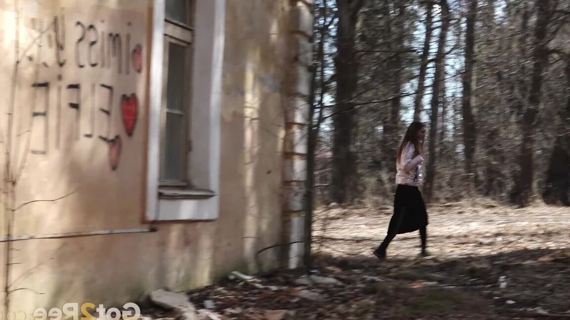 15P Short taken girl Vika squats for a piss behind a graffitied building