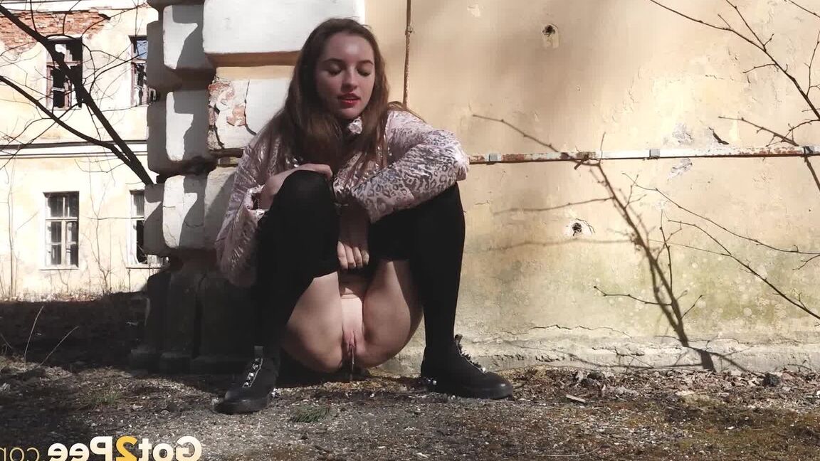 15P Short taken girl Vika squats for a piss behind a graffitied building