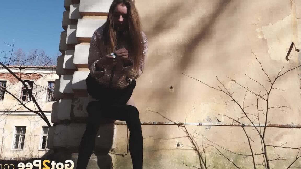 15P Short taken girl Vika squats for a piss behind a graffitied building