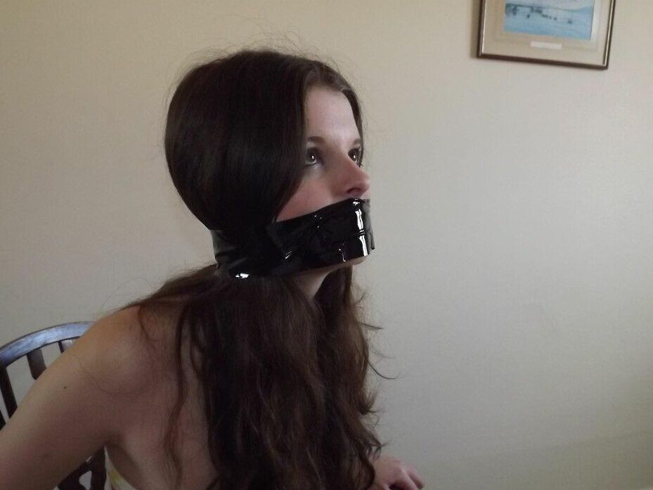 16P Clothed girl Tamara looks in a mirror while gagged and restrained to a chair