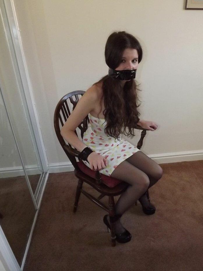 16P Clothed girl Tamara looks in a mirror while gagged and restrained to a chair