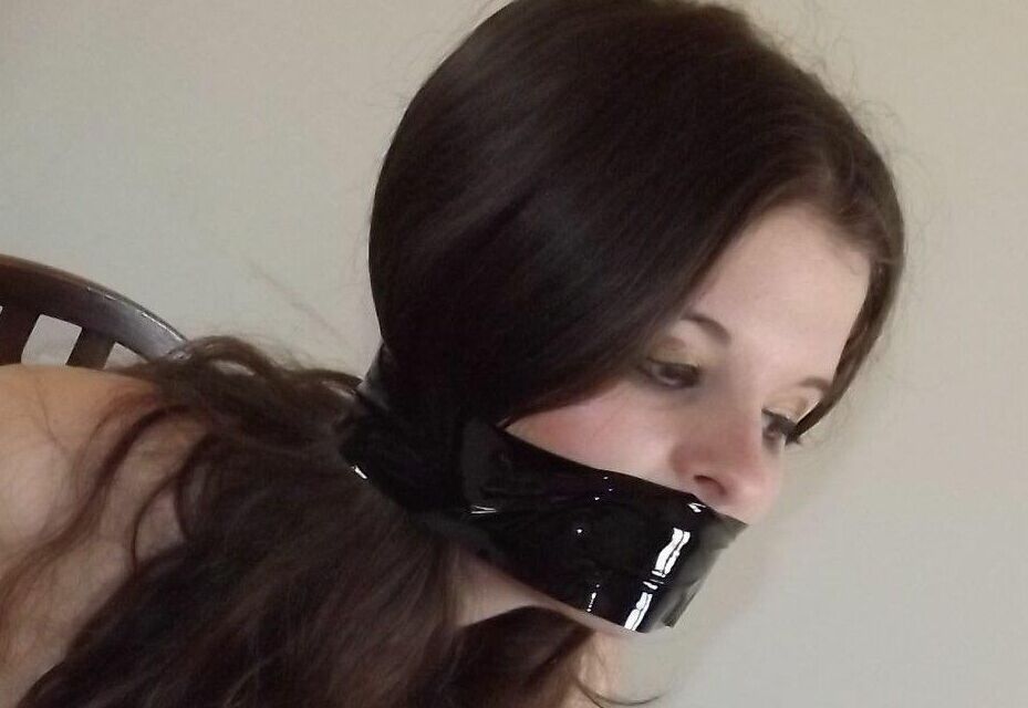 16P Clothed girl Tamara looks in a mirror while gagged and restrained to a chair