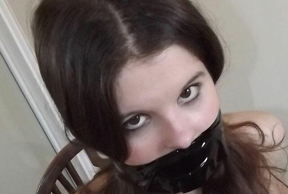 16P Clothed girl Tamara looks in a mirror while gagged and restrained to a chair