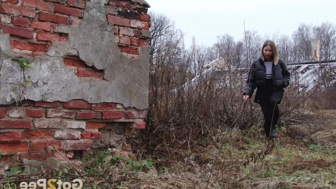 15P Solo girl pulls down her pantyhose for a piss by an abandoned building
