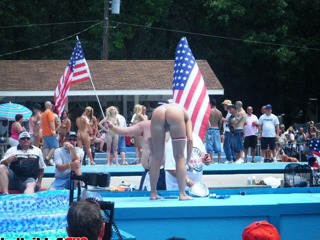 12P Multiple naked strippers on stage at an ourdoor public nudity party