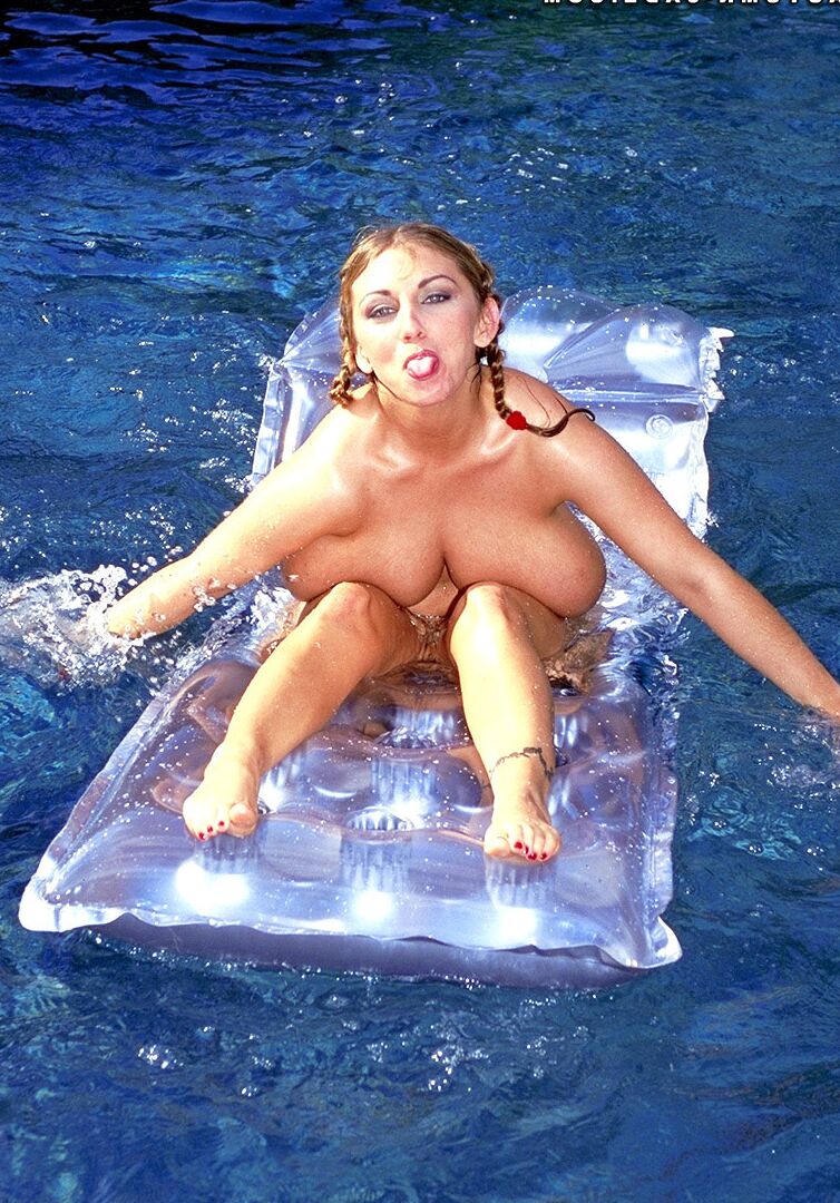 21P Babe with pigtails Autumn Jade flaunts her monster tits in the pool