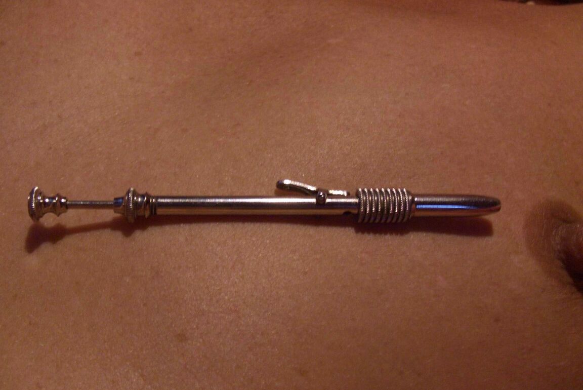 12P Close up action of a female having her breasts tortured with needles