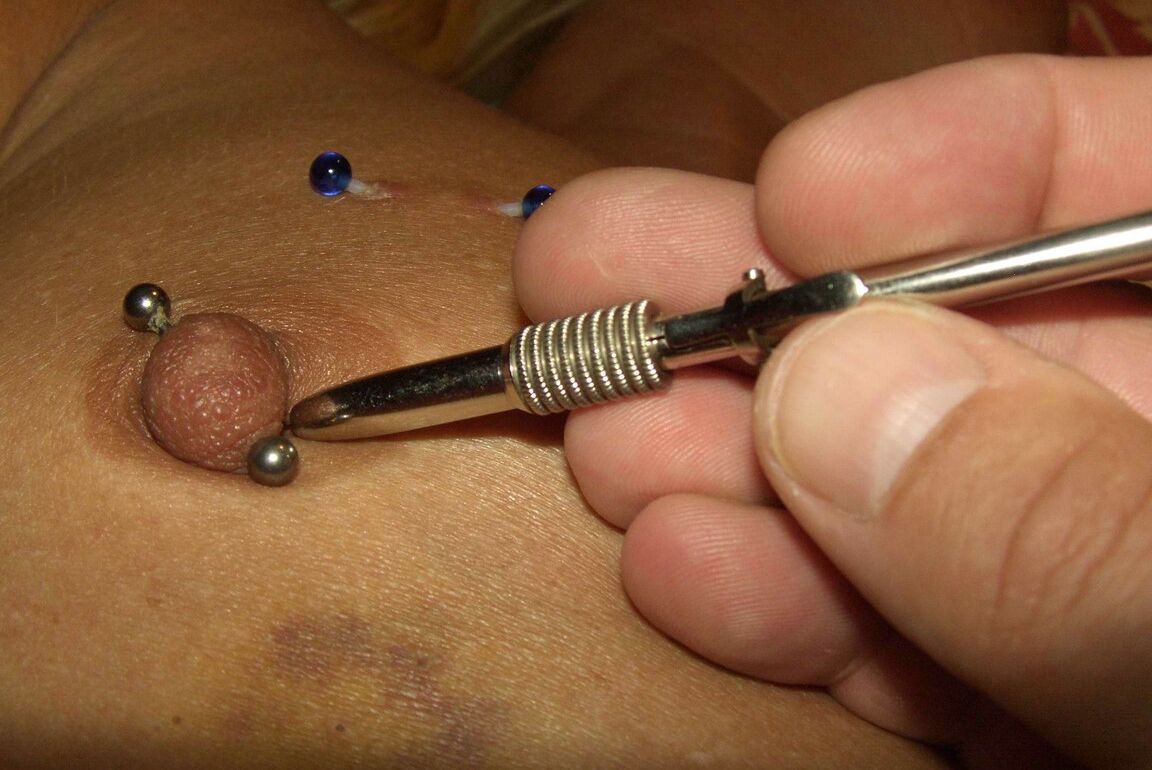 12P Close up action of a female having her breasts tortured with needles