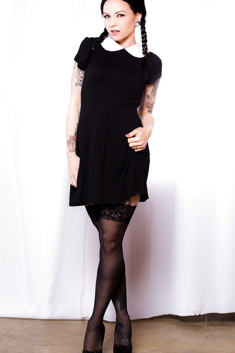 15P Fetish model Necro Nicki posing in stockings and garters with hair in pigtails