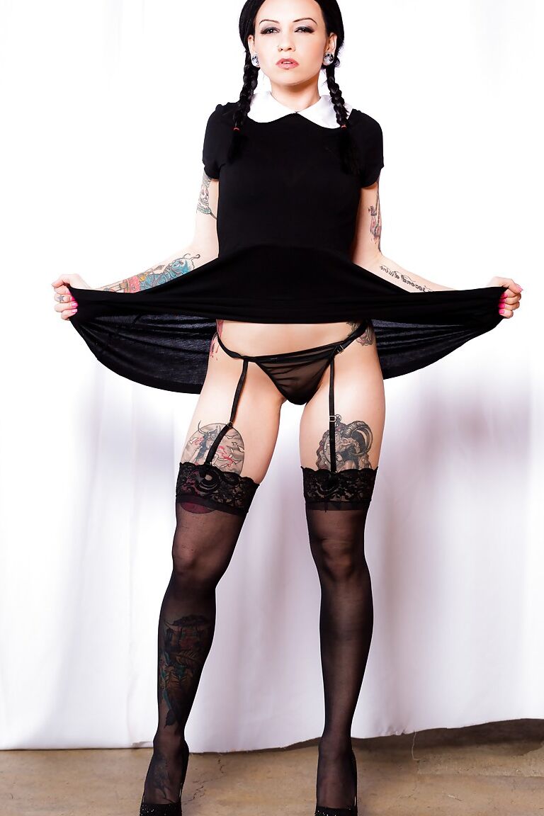 15P Fetish model Necro Nicki posing in stockings and garters with hair in pigtails